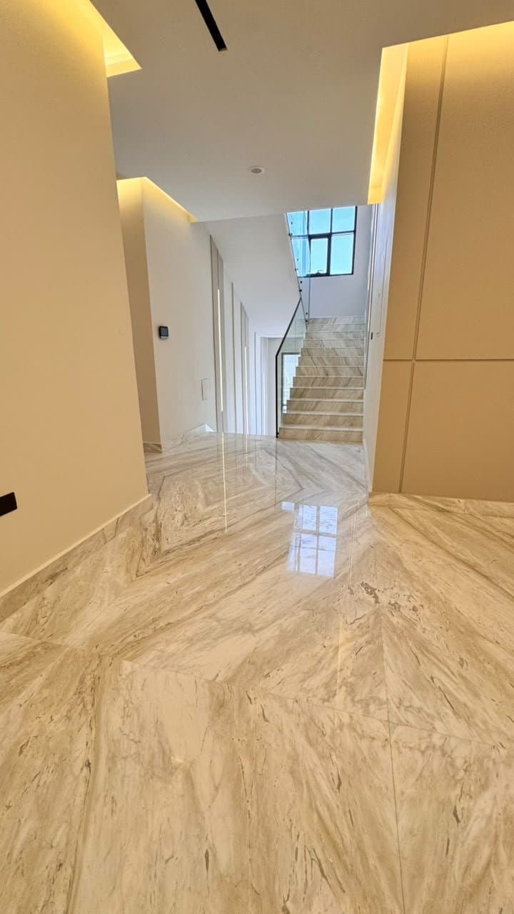 Marble flooring in a hallway leading to a staircase