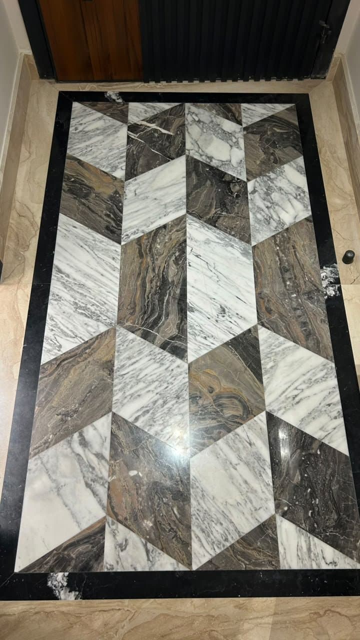 Geometric bookmatched marble floor medallion at an entryway