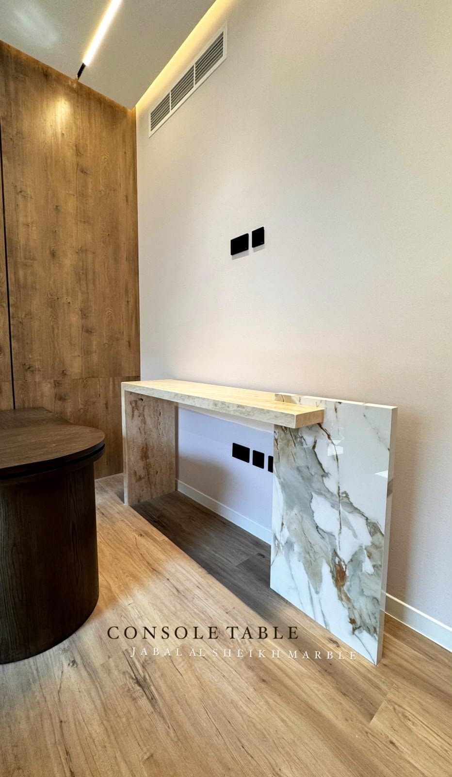 Console table with a book-matched Calacatta gold marble waterfall leg