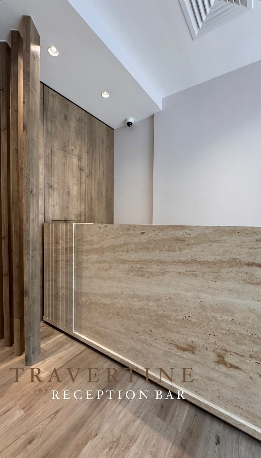 Travertine reception bar with fluted edge detail