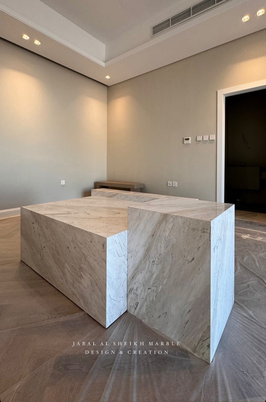 Sculptural angular marble coffee table with book-matched veining