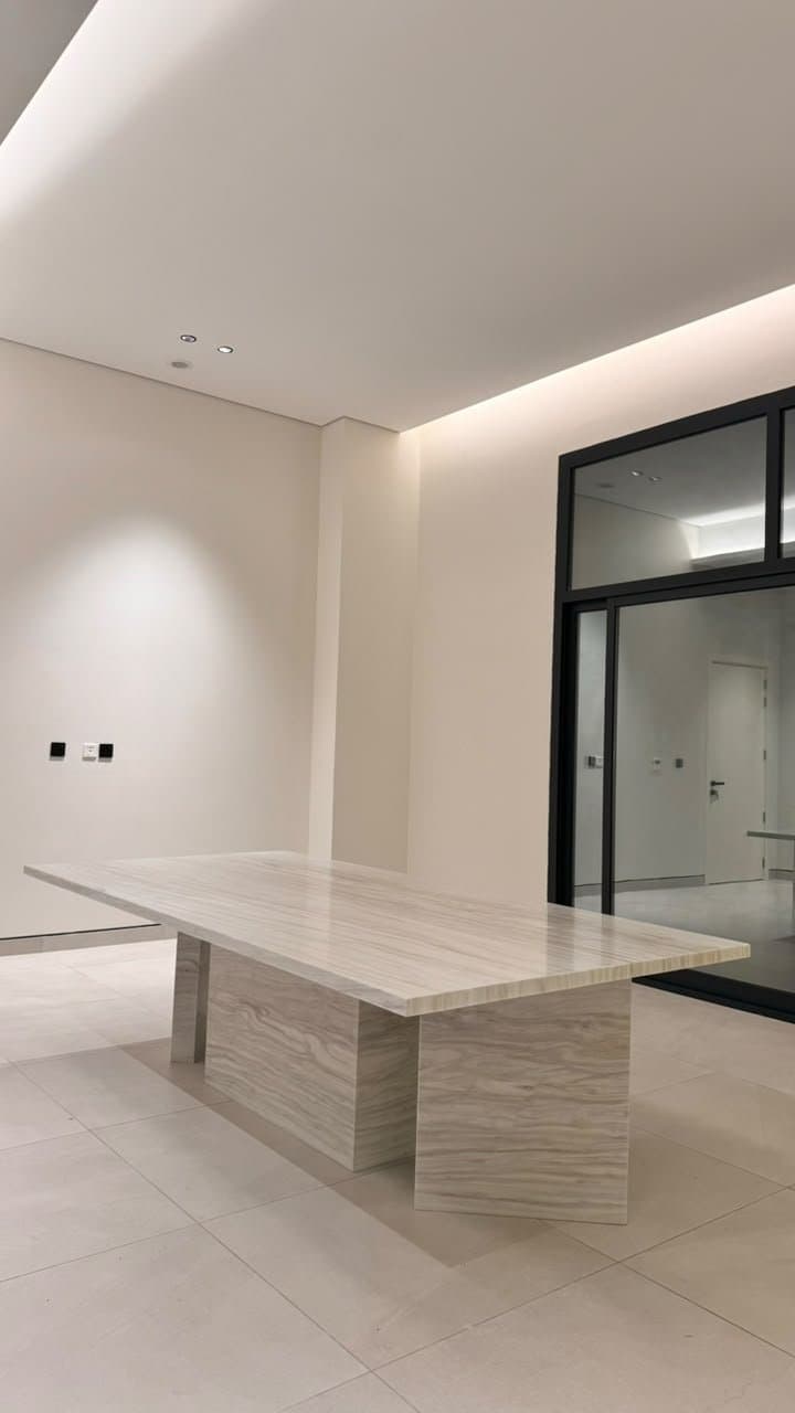 Rectangular travertine dining table on twin pedestal bases