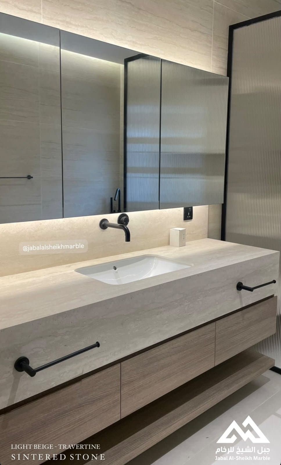 Light beige travertine and sintered stone vanity with undermount sink