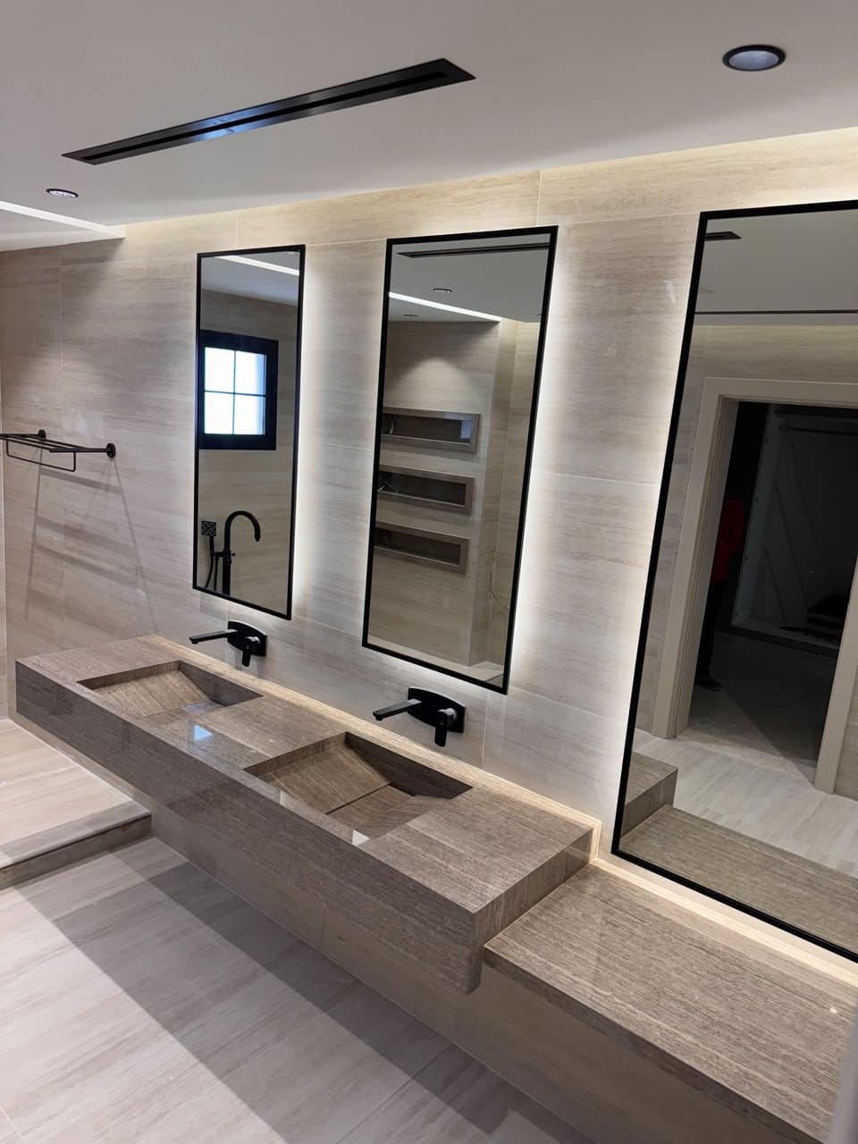 Grey travertine double sink vanity with tall rectangular mirrors