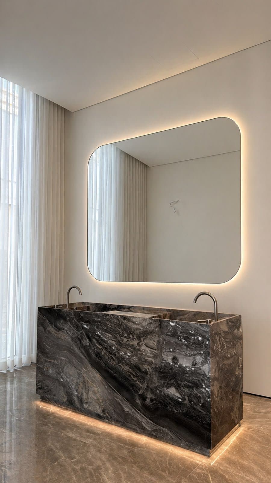 Dark swirled marble double trough vanity with rounded backlit mirror