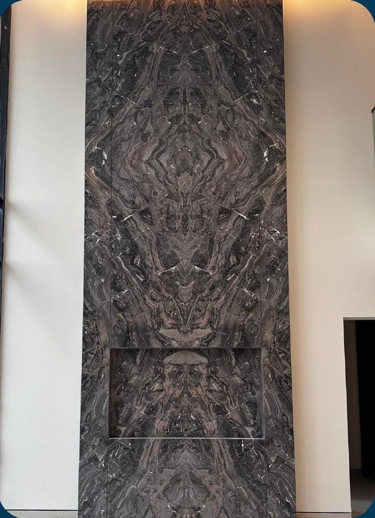 Bookmatched marble slab, floor to ceiling