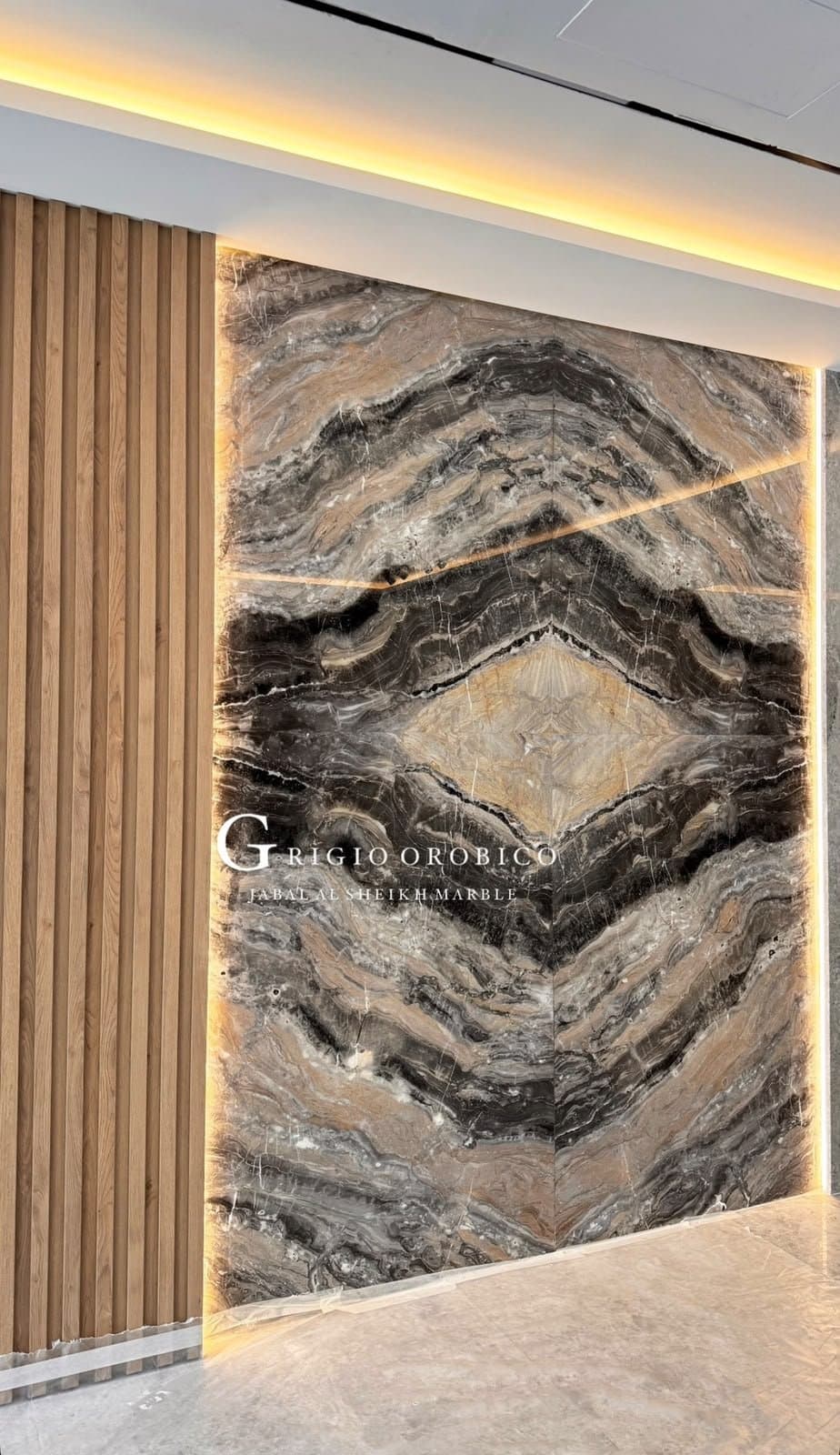 Grigio Orobico bookmatched marble feature wall beside timber battens