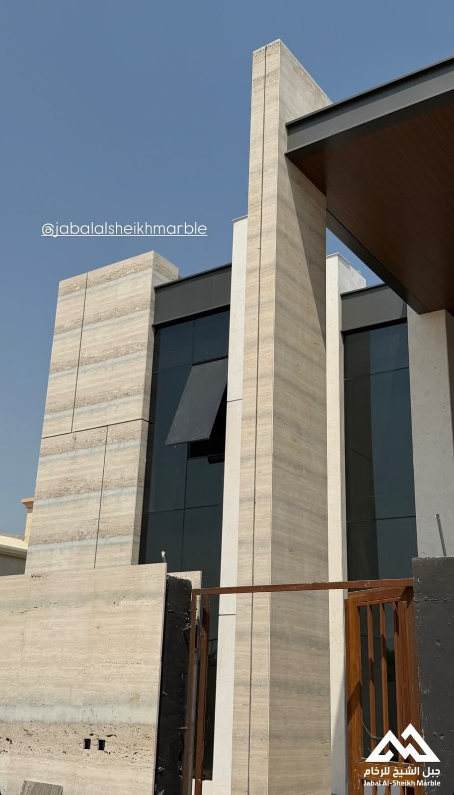 Fluted travertine cladding on an exterior facade and columns