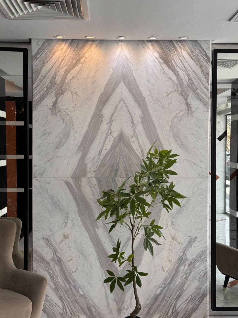 Bookmatched marble feature wall with diamond veining in a reception lobby