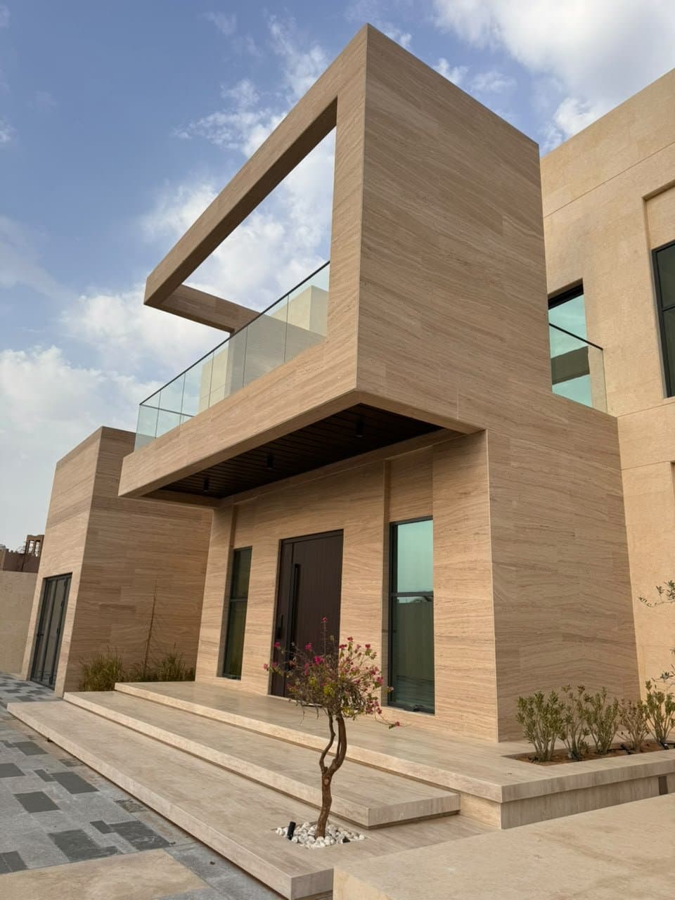 Fluted travertine cladding on a modern villa exterior facade